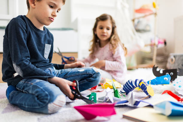 istock Kids making origami crafts with paper 1212822518