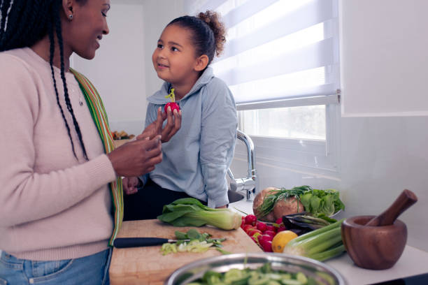 istock Mother and daughter bonding, cooking together in the kitchen. 1212822533