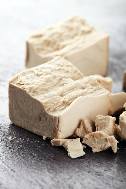 istock Dry yeast crumbled and yeast block for baking on background 1212822557