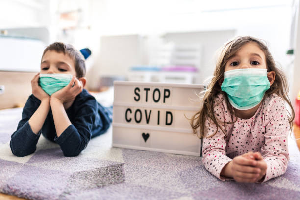 istock Children wearing pollution masks at home 1212822697