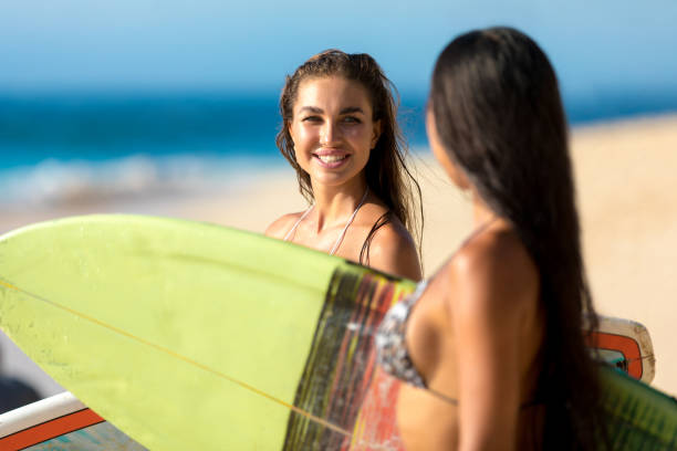 istock Two woman surfers at the beach 1212822712