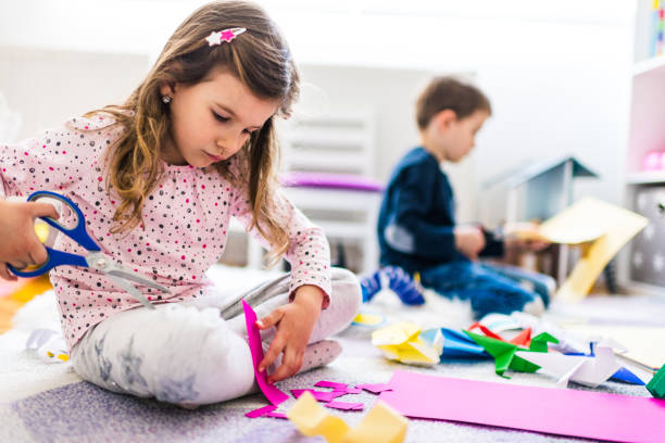 istock Kids making origami crafts with paper 1212822752