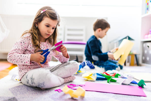 Kids making origami crafts with paper