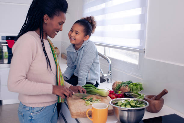 istock Mother and daughter cooking together. 1212822976