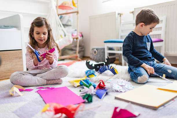 istock Kids making origami crafts with paper 1212823071