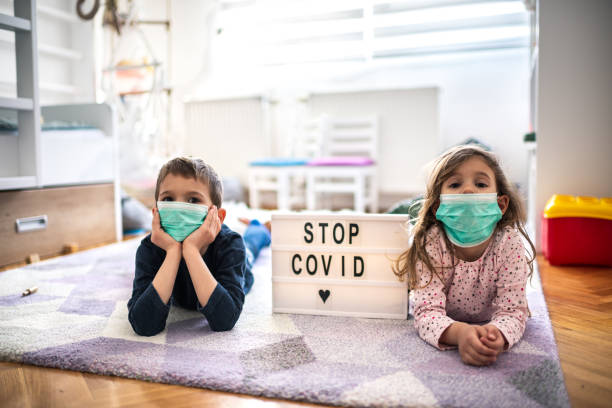 istock Children wearing pollution masks at home 1212823666