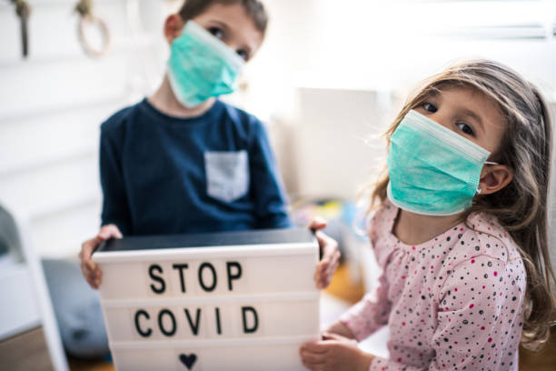 istock Children wearing pollution masks at home 1212823732