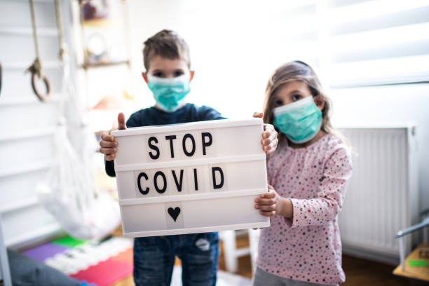 istock Children wearing pollution masks at home 1212823757