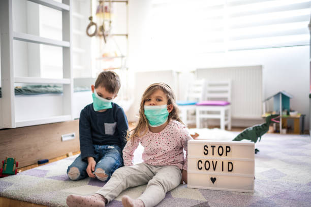 istock Children wearing pollution masks at home 1212823800
