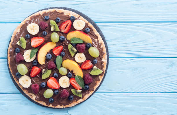 istock Fruit pizza with nut nougat cream , fruit and berries 1212823853