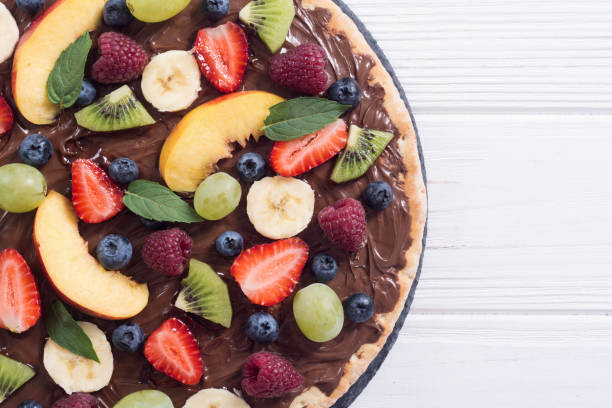 istock Fruit pizza with nut nougat cream , fruit and berries 1212824194