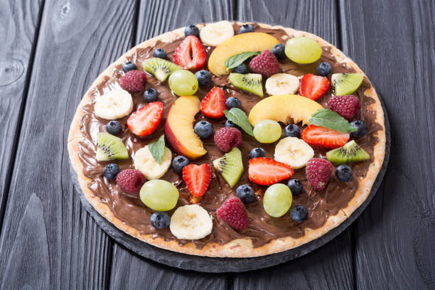 istock Fruit pizza with nut nougat cream , fruit and berries 1212824210
