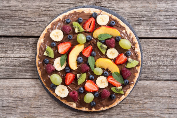 istock Fruit pizza with nut nougat cream , fruit and berries 1212824459