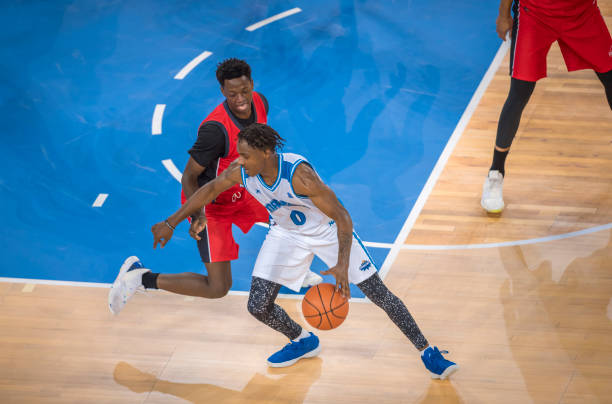 istock Basketball players tackling for ball 1212827918