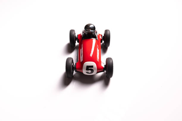 istock Red toy racing car with number five painted on it and silver helmet isolated on a white background 1212828152
