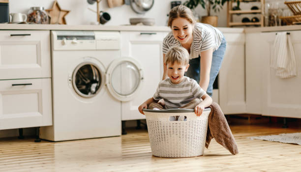 istock Happy mother playing with son in kitchen 1212830426