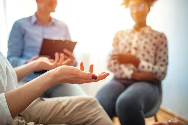 istock Close-up of therapist's hands explaining a problem to his patients. 1212830672