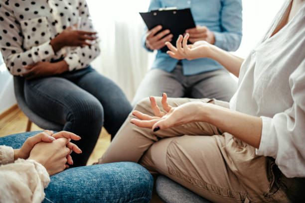 istock Unrecognizable vulnerable woman participates in group therapy session. 1212830701