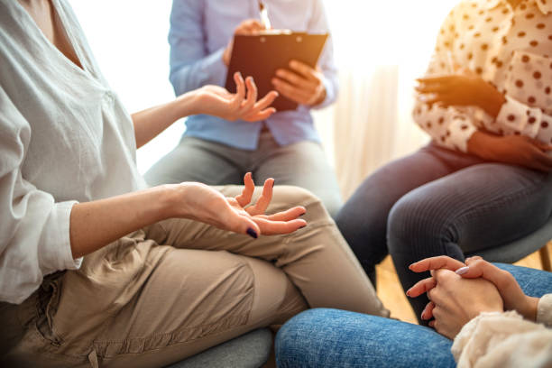 istock Close-up of therapist's hands explaining a problem to his patients 1212830728