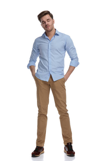 istock Tired casual man holding eyes closed and hands in pockets 1212831473