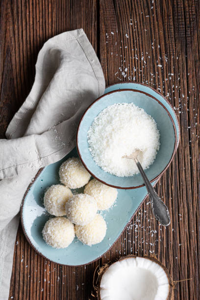 Delicious no bake candy, white chocolate truffles covered in shredded coconut stock photo