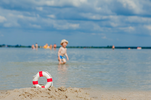 Close-up Of Lifebuoy on the beach on baby background. Safety on the water