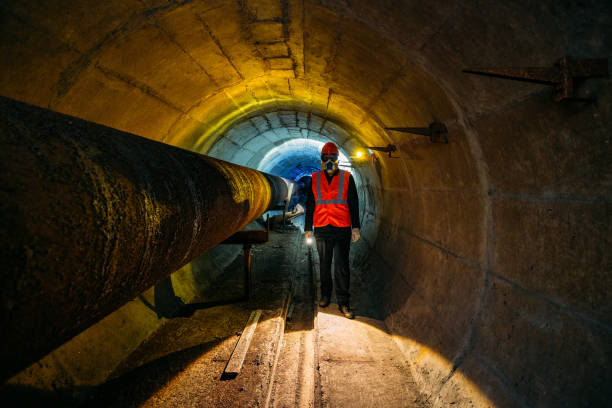 istock Tunnel worker examines pipeline in underground tunnel 1212837089
