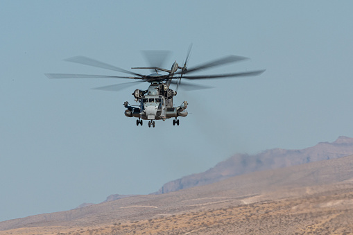 CH-53 Sea Stallion helicopter in flight, against the Nevada hills