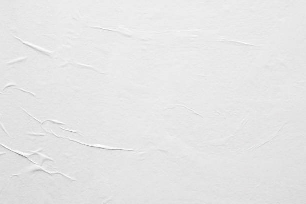 istock Blank white crumpled and creased paper poster texture background 1212840358