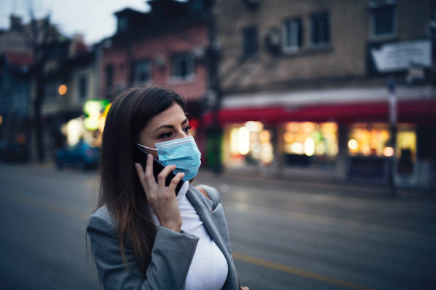 istock Woman With Protective Mask Talking On The Phone 1212841004