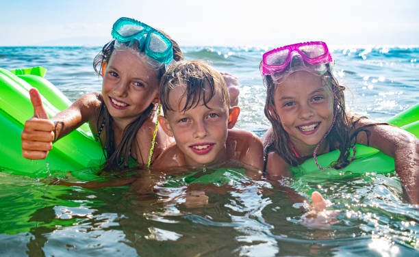 istock Borther and sisters in the sea 1212841879