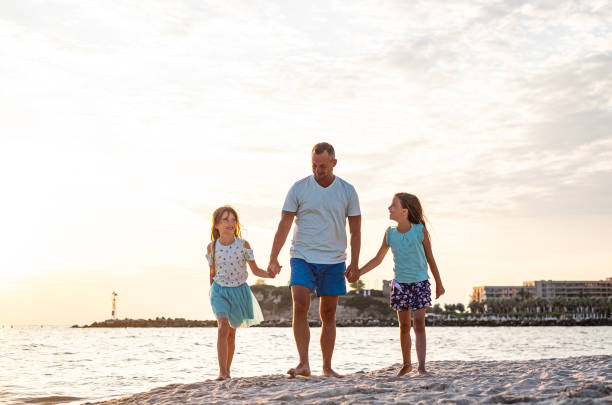 istock Family walking on the beach 1212841940