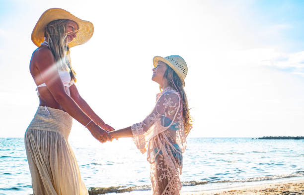 istock Mother and daughter on beach 1212842552