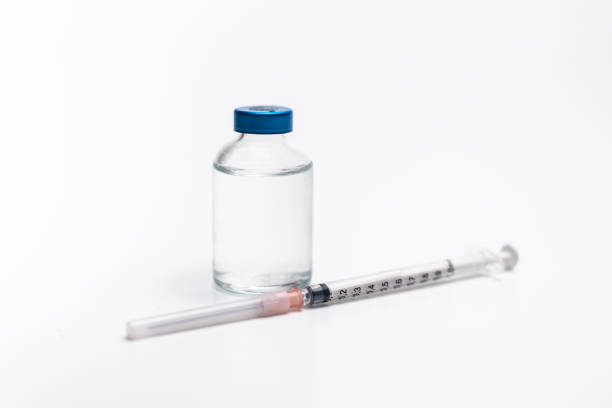 istock vaccine in a glass bottle and a syringe white background 1212842738