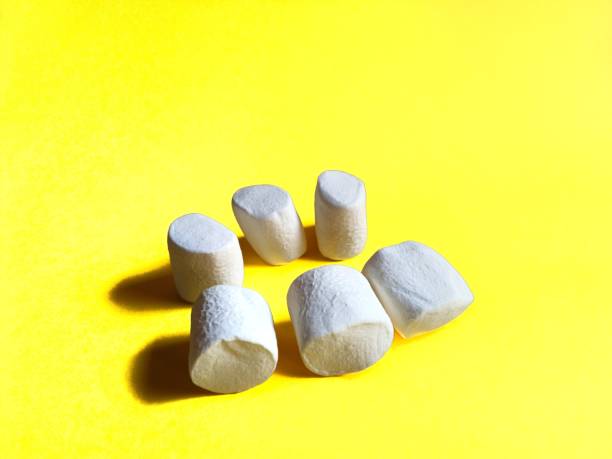 istock Marshmallows on yellow background. holidays concept 1212848381