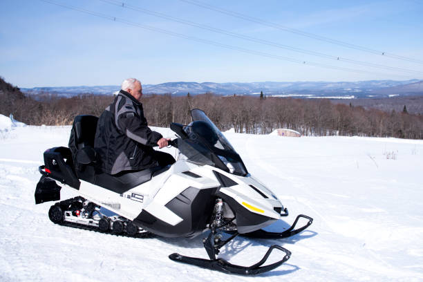 istock A Man on snowmobile in winter mountain 1212848582