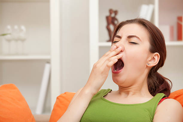 istock Woman yawning in the sofa at home 121285145