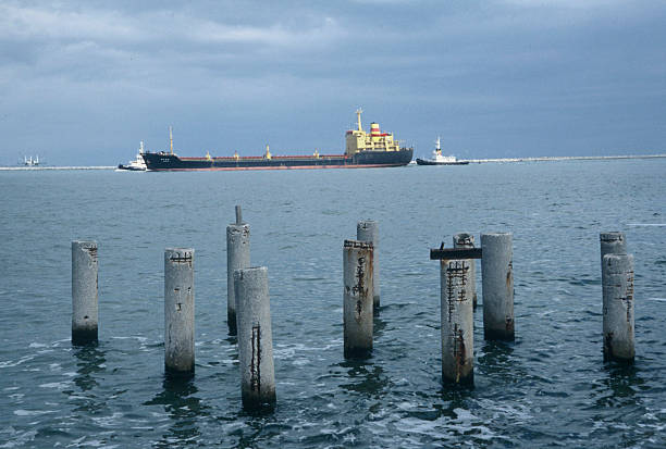 istock Tugboats escorting ship leaving port, Italy 121286107