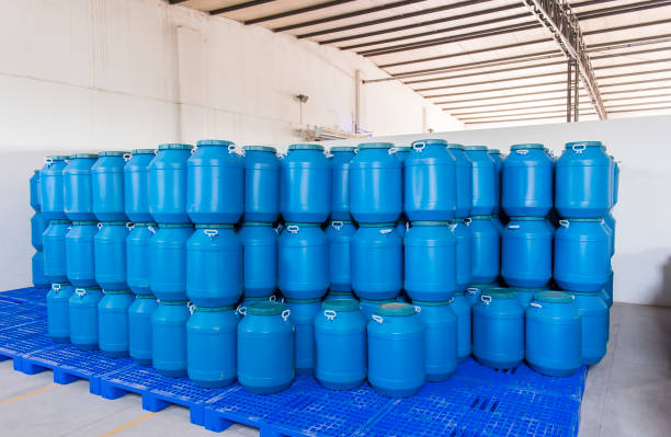 istock Plastic barrels or drums stored in a warehouse 1212864292