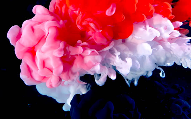 istock Red, white and black watercolor ink in water on a black background. 1212866151