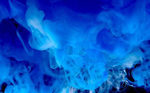 istock Blue watercolor ink in water on a black background. Cosmic magic background. Blue abstract background. 1212866159