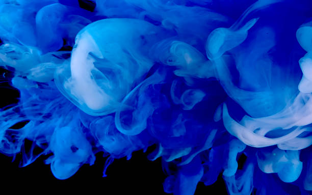 istock Blue watercolor ink in water on a black background. Cosmic magic background. 1212866172