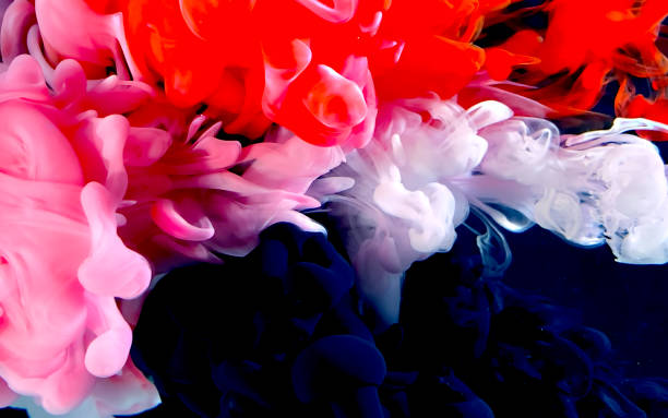 istock Red, white and black watercolor ink in water on a black background. 1212866215