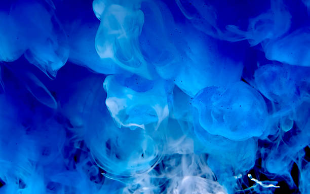 istock Blue watercolor ink in water on a black background. Cosmic magic background. Blue abstract background. 1212866220