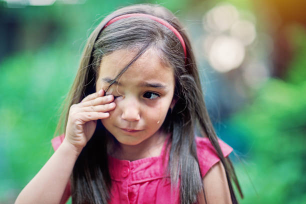 single happy kid girl child walking in the garden, close up head and shoulders, long hair