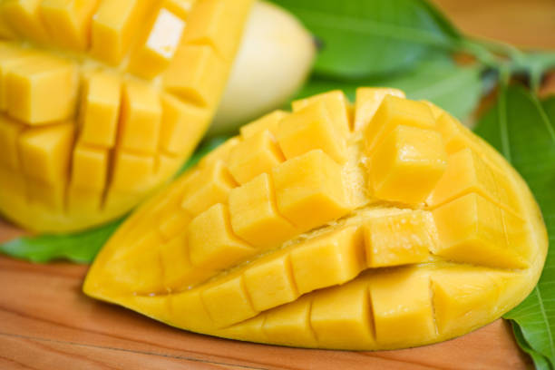 istock Sweet ripe mangos cut - Mango slice and mango leaves from tree tropical summer fruit concept 1212866448