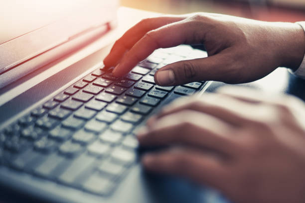 istock Businessman working on keyboard computer laptop man sitting on the table and using internet technology at workplace in office - Male hand typing on keyboard concept 1212866494