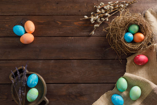 istock Still life many colorful easter eggs on a wooden background. Rustic. Decoration from natural fabrics and herbs. Easter celebration concept. Flat lay 1212871704