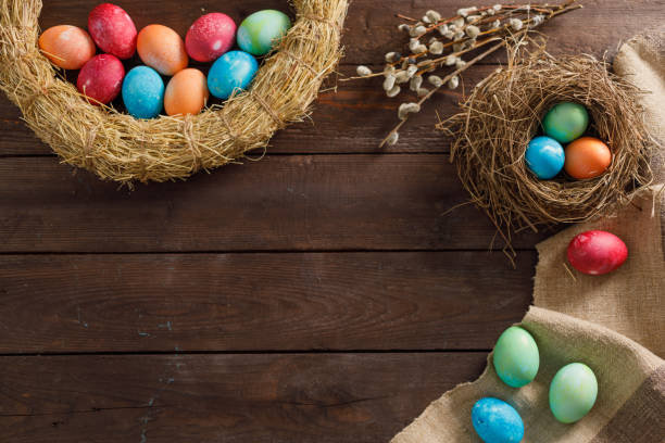 istock Still life many colorful easter eggs on a wooden background. Rustic. Decoration from natural fabrics and herbs. Easter celebration concept. Flat lay 1212871719