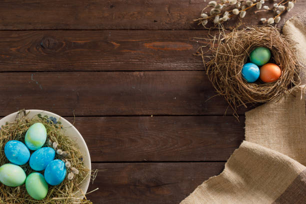 istock Still life many colorful easter eggs on a wooden background. Rustic. Decoration from natural fabrics and herbs. Easter celebration concept. Flat lay 1212871740
